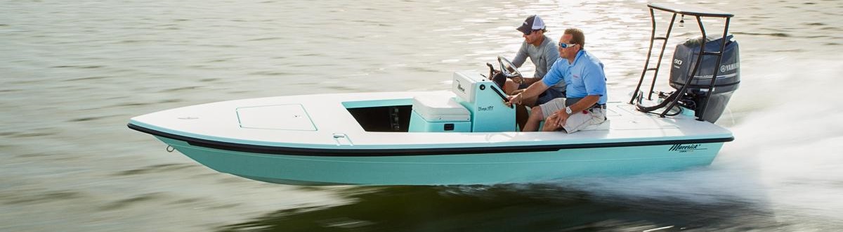 Two men on a Aqua marine boat dashing through a lake.